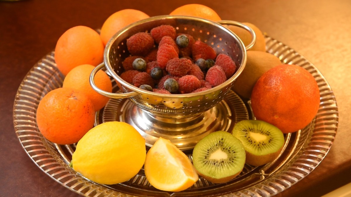 Fruit salad ingredients on a glass plate and colander