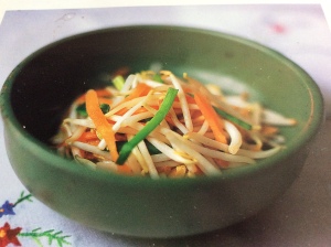 Asian bean sprout salad with carrots in a green bowl