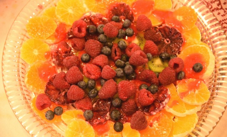 beautiful fruit salad with oranges, raspberries, kiwi and blueberries