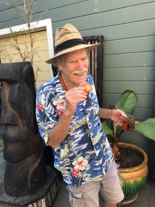 Rick eating a dried persimmon and holdin a tea cup with one in the tea 