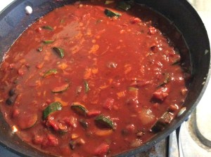 cooking the vegetable and chicken in the sauce